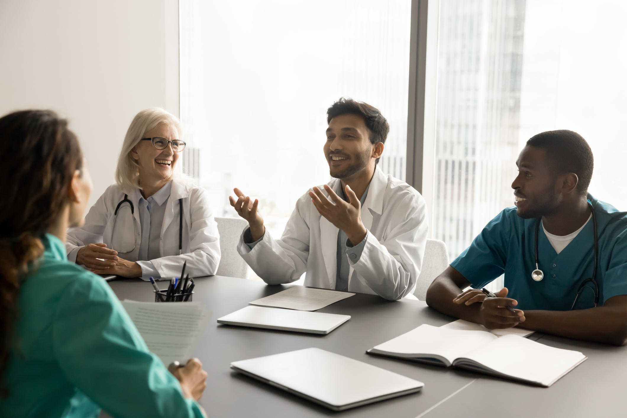 medical team talking at meeting table