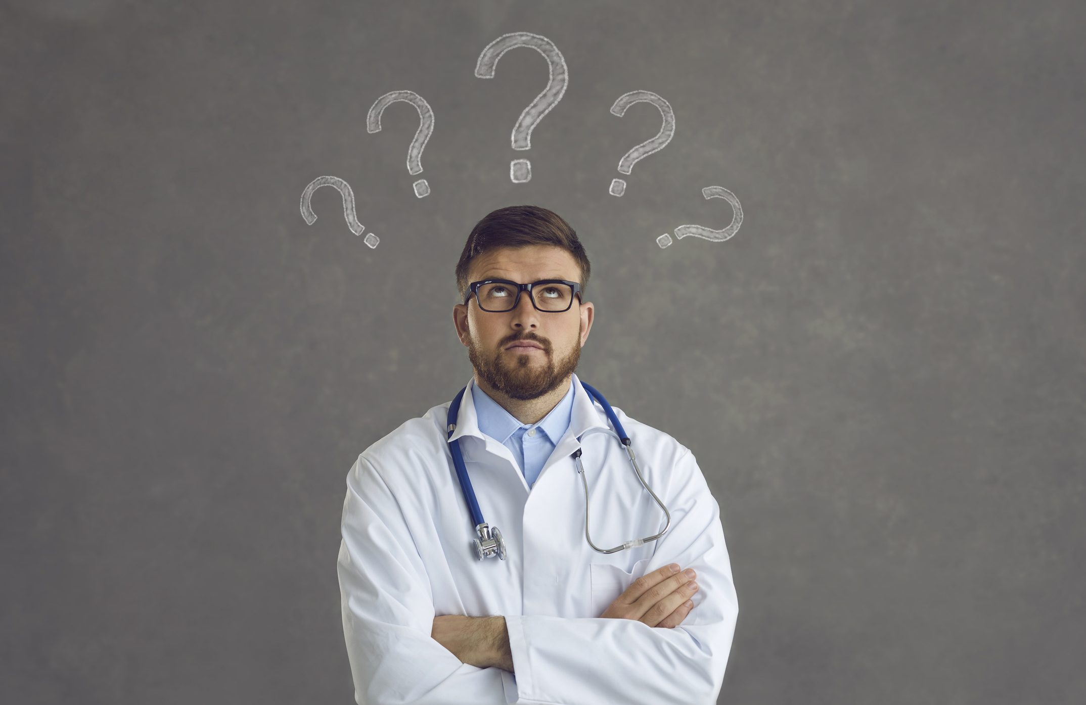 Doctor with question marks above head
