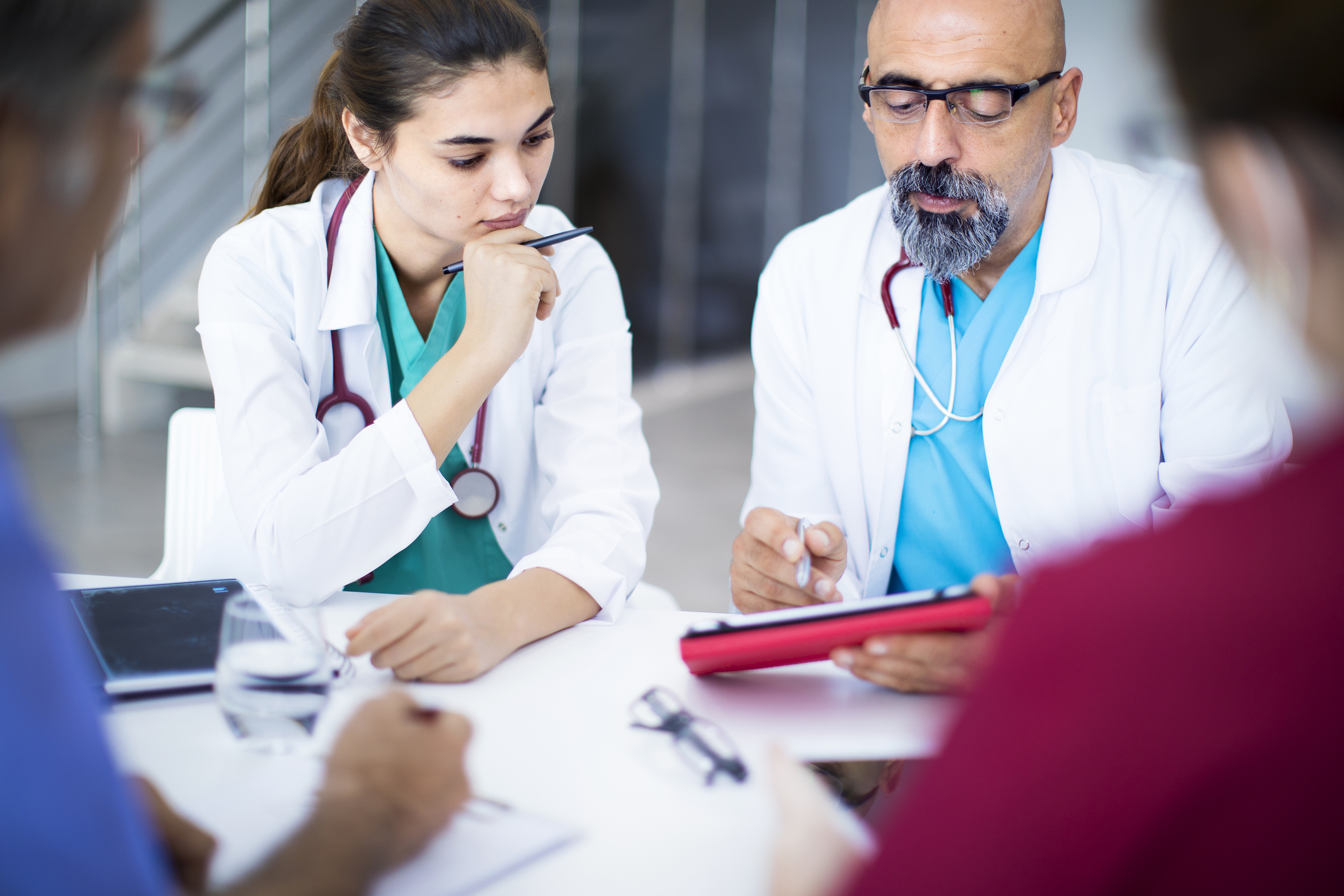 Physician mentoring medical student during patient care
